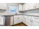 Close up of kitchen featuring white cabinets, stainless steel appliances, and a garden window at 503 Countryside Se Pl, Smyrna, GA 30080