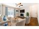 Cozy living room features a ceiling fan, fireplace, hardwood floors, and ample natural light at 503 Countryside Se Pl, Smyrna, GA 30080
