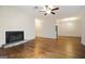 Living room featuring hardwood floors, a fireplace, ceiling fan, and open access to the dining room at 503 Countryside Se Pl, Smyrna, GA 30080