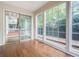 Sunroom with hardwood floors and multiple windows that lead to a balcony at 503 Countryside Se Pl, Smyrna, GA 30080