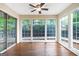 Empty sunroom featuring hardwood floors and multiple windows for natural lighting at 503 Countryside Se Pl, Smyrna, GA 30080