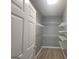 Walk-in closet with organized shelving system for efficient storage at 1392 Orchard Park Dr, Stone Mountain, GA 30083