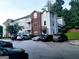 Charming apartment complex featuring brick accents, well-maintained landscaping, and ample parking spaces at 1392 Orchard Park Dr, Stone Mountain, GA 30083