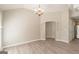Open living area with hardwood style flooring, neutral paint, arched doorways, and a view into the kitchen at 1392 Orchard Park Dr, Stone Mountain, GA 30083