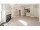 Bright open living space with fireplace, columns, neutral paint, and hardwood style flooring at 1392 Orchard Park Dr, Stone Mountain, GA 30083