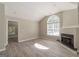 Inviting living room features vaulted ceiling, large window, and fireplace at 1392 Orchard Park Dr, Stone Mountain, GA 30083