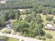 Aerial view of property lines surrounded by mature trees with a pool to the left and a pool to the right at 306 Tyrone Rd, Fayetteville, GA 30214