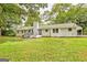 White brick home with sprawling backyard, featuring mature trees at 306 Tyrone Rd, Fayetteville, GA 30214