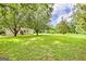 Expansive backyard featuring lush green lawn and mature trees, offering privacy and plenty of space at 306 Tyrone Rd, Fayetteville, GA 30214