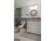 Stylish bathroom featuring modern vanity, glass shower, and decorative mirror at 306 Tyrone Rd, Fayetteville, GA 30214