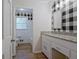 Bathroom featuring granite countertop and black and white checkered accent wall at 306 Tyrone Rd, Fayetteville, GA 30214
