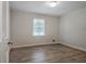 Bright bedroom with wood flooring and a large window offering natural light at 306 Tyrone Rd, Fayetteville, GA 30214