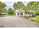 Charming home with a large driveway and detached garage surrounded by mature trees at 306 Tyrone Rd, Fayetteville, GA 30214
