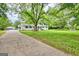 White, one-story home with lush lawn, long driveway and detached garage at 306 Tyrone Rd, Fayetteville, GA 30214