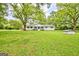 Charming one-story home featuring a beautifully landscaped yard with mature trees and a quaint exterior at 306 Tyrone Rd, Fayetteville, GA 30214
