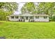 Traditional home with a covered front porch, columns and lush landscaping at 306 Tyrone Rd, Fayetteville, GA 30214