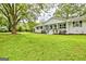 Charming one-story home with lush green lawn, mature trees and inviting front porch at 306 Tyrone Rd, Fayetteville, GA 30214