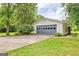 Exterior view of detached garage featuring gated access, lush yard, and landscaping at 306 Tyrone Rd, Fayetteville, GA 30214