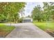 Exterior view of the detached garage and lush yard and gated access at 306 Tyrone Rd, Fayetteville, GA 30214