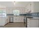 Updated kitchen with stainless steel appliances and tile backsplash at 306 Tyrone Rd, Fayetteville, GA 30214