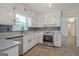 Bright kitchen featuring stainless steel appliances and granite countertops at 306 Tyrone Rd, Fayetteville, GA 30214