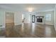 Spacious living room with fireplace, wood floors, and access to other rooms at 306 Tyrone Rd, Fayetteville, GA 30214