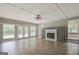 Spacious living room featuring a fireplace, detailed ceiling, and multiple windows at 306 Tyrone Rd, Fayetteville, GA 30214