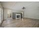 Living room with hardwood floors, fireplace, and access to another room at 306 Tyrone Rd, Fayetteville, GA 30214