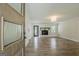 Open-concept living room featuring refinished hardwood flooring and a white brick fireplace at 306 Tyrone Rd, Fayetteville, GA 30214