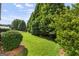 A lush green backyard with neatly trimmed trees and shrubs offers a private outdoor space at 545 Grand Teton Cir, Fayetteville, GA 30215
