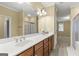 Bathroom featuring a large mirror, double sinks, and abundant storage in a stylish vanity at 545 Grand Teton Cir, Fayetteville, GA 30215