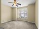 Bedroom features a ceiling fan, a window with blinds, and neutral-toned walls, creating a calming atmosphere at 545 Grand Teton Cir, Fayetteville, GA 30215
