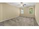 Comfortable bedroom featuring plush carpeting, a ceiling fan, and natural light from the windows at 545 Grand Teton Cir, Fayetteville, GA 30215
