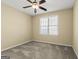 Bedroom features a ceiling fan, window with blinds, and neutral-toned walls, enhancing natural light at 545 Grand Teton Cir, Fayetteville, GA 30215