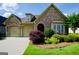 Charming home with stone accents, arched entryway, well-manicured lawn, and a two-car garage at 545 Grand Teton Cir, Fayetteville, GA 30215