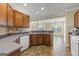 Well-lit kitchen with stainless steel sink, wood cabinets, and tile flooring at 545 Grand Teton Cir, Fayetteville, GA 30215