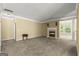 Relaxing living room area featuring plush carpeting, fireplace, and natural light with a view of the outdoors at 545 Grand Teton Cir, Fayetteville, GA 30215