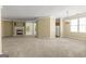 Expansive living room with fireplace, carpet, and access to dining and kitchen areas at 545 Grand Teton Cir, Fayetteville, GA 30215