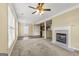 Spacious living room with ceiling fan, fireplace, carpet, and plenty of natural light at 545 Grand Teton Cir, Fayetteville, GA 30215