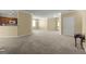 Expansive living space featuring a functional layout, neutral walls, plush carpet, and seamless transitions to other rooms at 545 Grand Teton Cir, Fayetteville, GA 30215