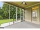 Comfortable screened-in porch with a ceiling fan offers a view of the green backyard at 545 Grand Teton Cir, Fayetteville, GA 30215