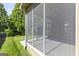 View of the screened-in porch and manicured backyard, providing a relaxing outdoor living space at 545 Grand Teton Cir, Fayetteville, GA 30215