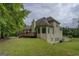 Back exterior view shows a raised deck and large windows overlooking the private yard at 235 Rustic Mill Ln, Fayetteville, GA 30214