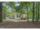 Exterior showcases a backyard with mature trees, a deck, and well-maintained grounds at 235 Rustic Mill Ln, Fayetteville, GA 30214