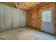 Unfinished basement with exposed beams, and an access door to the outside at 235 Rustic Mill Ln, Fayetteville, GA 30214