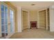 Finished basement featuring built-in bookshelves, a fireplace, and a glass panel door at 235 Rustic Mill Ln, Fayetteville, GA 30214
