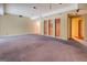 Spacious basement area with carpeted floor, recessed lighting, and built-in shelves at 235 Rustic Mill Ln, Fayetteville, GA 30214