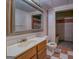Bathroom featuring a vanity sink, toilet, shower, and checkered tile flooring at 235 Rustic Mill Ln, Fayetteville, GA 30214