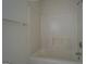 Full bathtub with shower and white tile surround at 235 Rustic Mill Ln, Fayetteville, GA 30214