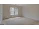 Bedroom with carpeted floor and a window with blinds that provide natural light at 235 Rustic Mill Ln, Fayetteville, GA 30214